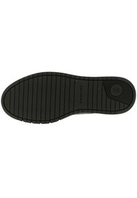 Semelle de chaussure en caoutchouc noir avec des rainures horizontales et verticales, présentant un logo circulaire et un motif texturé pour l'adhérence.