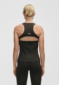 Czarny sportowy top bez rękawów z wycięciem na plecach, z logo w białym kolorze. Gładki materiał.