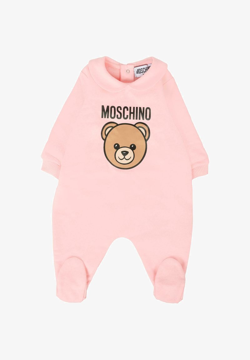 Pink baby onesie made of soft fabric, featuring a rounded collar, a bear graphic, and the text "MOSCHINO" above it. Footed design with cuffs.