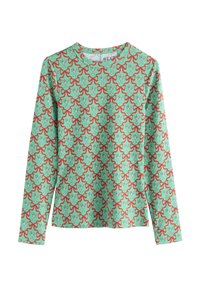 Chemise à manches longues en tissu vert menthe. Présente un motif répétitif de nœuds rouges et de petits éléments blancs, avec un col rond.