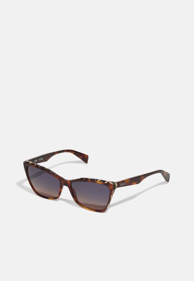 Ochelari de soare tortoise brown cu lentile gradient, design cu ramă pătrată și brațe proeminente cu un accent de imprimeu leopar pe lângă balamale.