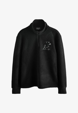 Mustmust käisepullover, millel on veerandzip, kus on tikitud Snoopy ja Woodstocki tegelased ning jaapani tekst rinnal.