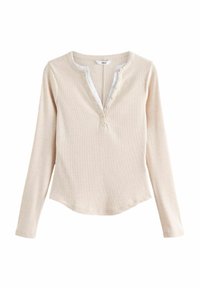 Maglietta beige a maniche lunghe con texture a costine, scollo a V con bordo bianco e cinque bottoni lungo il collo per la chiusura.
