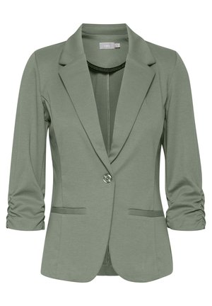 Zelený strečový blazer s klopovým golierom, jedným gombíkom a nariasenými tromi štvrtinovými rukávmi. Obsahuje dve predné vrecká.
