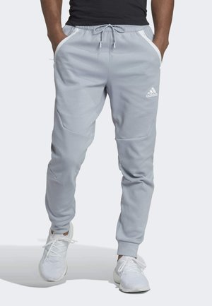 Light grey athletic joggers with white accents, elastic waistband, drawstring, and side pockets. Features tapered legs and ribbed cuffs.