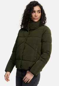 Olive green puffer jacket with a high collar, diagonal quilted pattern, and snap button details. Long sleeves and cropped fit.