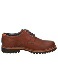 Scarpa in pelle marrone con punta rotonda, cuciture in evidenza, allacciatura frontale e suola testurizzata robusta. Presenta un tacco e una fodera interna a contrasto.