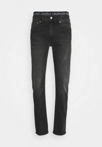 Černé džíny s rovnými nohavicemi, vyrobené z denimu. Mají pas s logem Calvin Klein a klasický design s pěti kapsami.