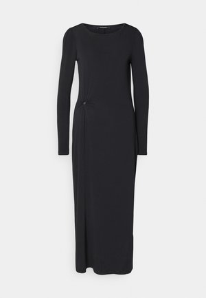 Czarna, długa sukienka z długim rękawem i okrągłym dekoltem, z boku ozdobiona węzłem i okrągłym akcentem, wykonana z gładkiego, elastycznego materiału.