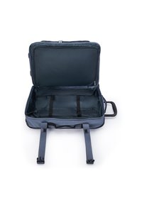 Open empty blue soft-sided suitcase with black interior straps and a black handle on white background.