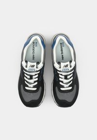 Black and gray sneakers with blue accents, featuring a textured upper, white laces, padded tongue, and a streamlined athletic design.