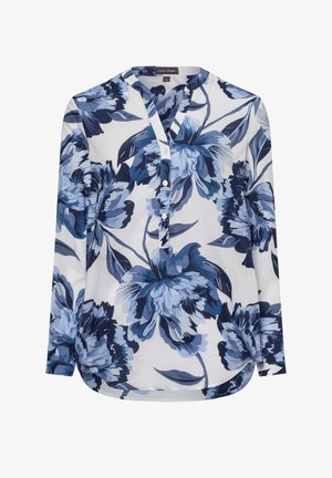 Long-sleeve shirt in white, featuring a blue floral pattern. Button-up front with a V-neckline and curved hem. Soft, lightweight fabric.