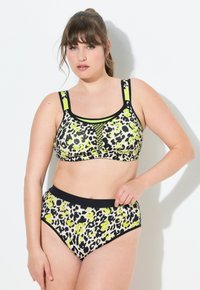 Bikini w print w panterę, z czarnym tłem i neonowymi zielonymi akcentami, z teksturowaną siateczką, szerokimi ramiączkami oraz wysokim stanem majtek, zapewniającym odpowiednie krycie.