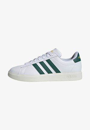 White sneakers with green three stripes and logo. Smooth synthetic upper, padded collar, and white rubber sole. Classic design.