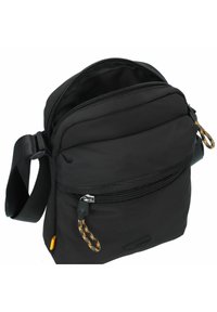 Black crossbody bag made of durable fabric, featuring a zippered main compartment, a front pocket, and a textured pull tab. Adjustable strap included.