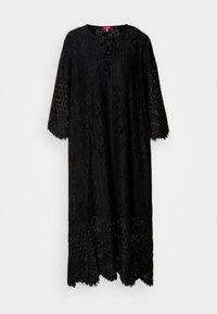 Black lace dress with a round neckline, three-quarter sleeves, intricate patterns, and a fringed hem; features a tied front closure.