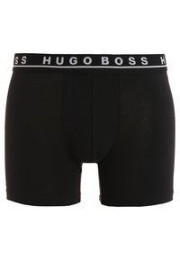 Schwarze Boxer-Briefs aus glattem Stoff, ausgestattet mit einem breiten elastischen Bund, auf dem "HUGO BOSS" in Weiß gedruckt ist. Klassisches Design mit körpernahem Schnitt.