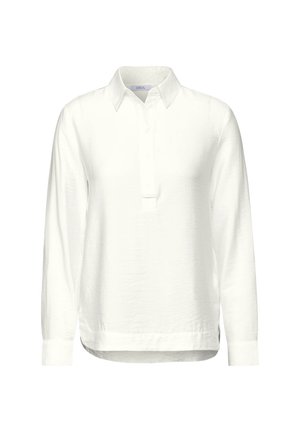 Camisa de polo blanca de manga larga con tapeta de botones y cuello clásico. Está hecha de una tela suave con un corte relajado y aberturas en los lados.