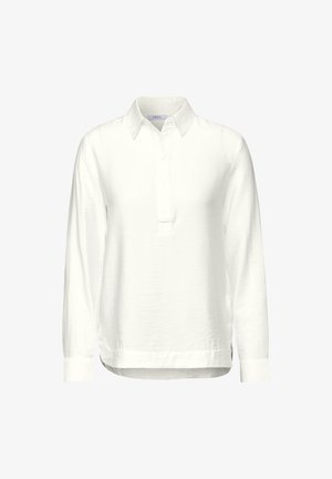 Camisa de polo blanca de manga larga con tapeta de botones y cuello clásico. Está hecha de una tela suave con un corte relajado y aberturas en los lados.