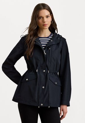 Navy blue rain jacket with a cinched waist, zipper front, adjustable hood, and two front pockets. Lightweight fabric with a smooth texture.