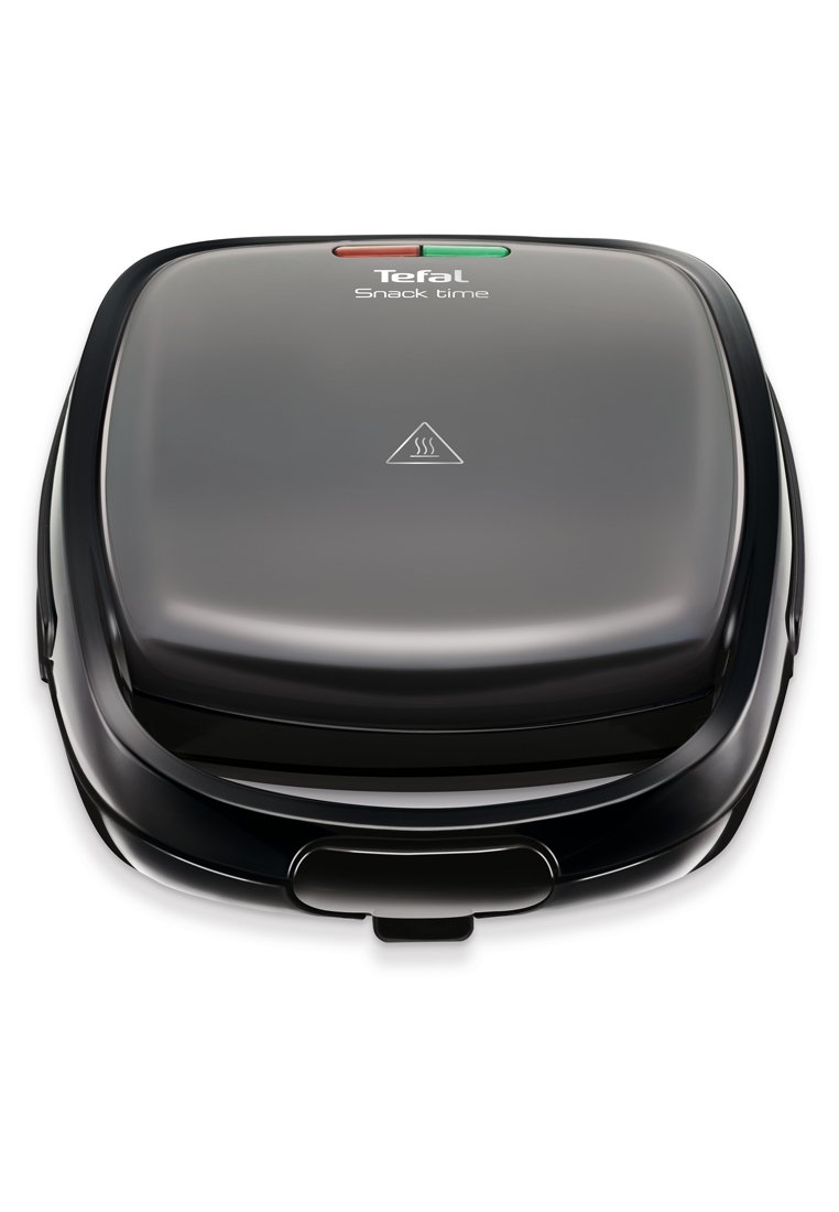 Sandwichera Tefal Snack Time negra con luces indicadoras y símbolo de advertencia de calor en la parte superior, cerrada y lista para usar.