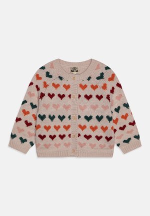 Light pink knitted baby cardigan with multicolored heart patterns in red, orange, green, and pink, buttoned down the front.