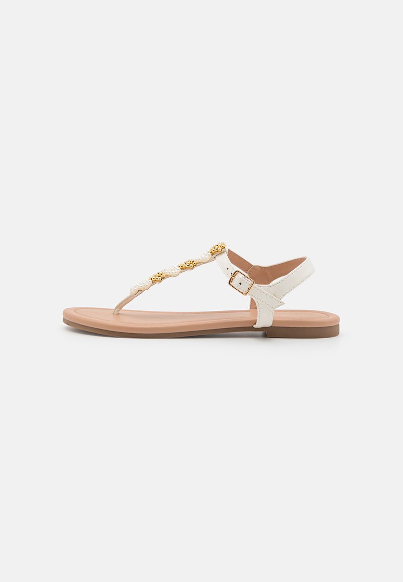 White synthetic flat sandal with adjustable ankle strap, decorative braided gold and white embellishments, and a light brown sole.