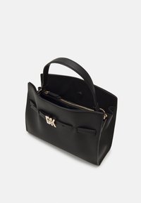 Black leather handbag with top handle, front strap detail with gold buckle, and inner zippered compartment, displayed on white background.