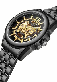 Zwarte automatische horloge met een transparante goudkleurige beweging. Beschikt over een zwarte armband, ronde kast, Romeinse cijfers en zilveren accenten.