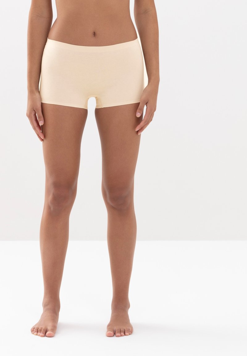 Vaalikapokankankuriset shortsit, joissa on joustava vyötärö, sileä pinta ja keskipitkä pituus reisiin. Ei näkyviä kuvioita tai metalliosia.