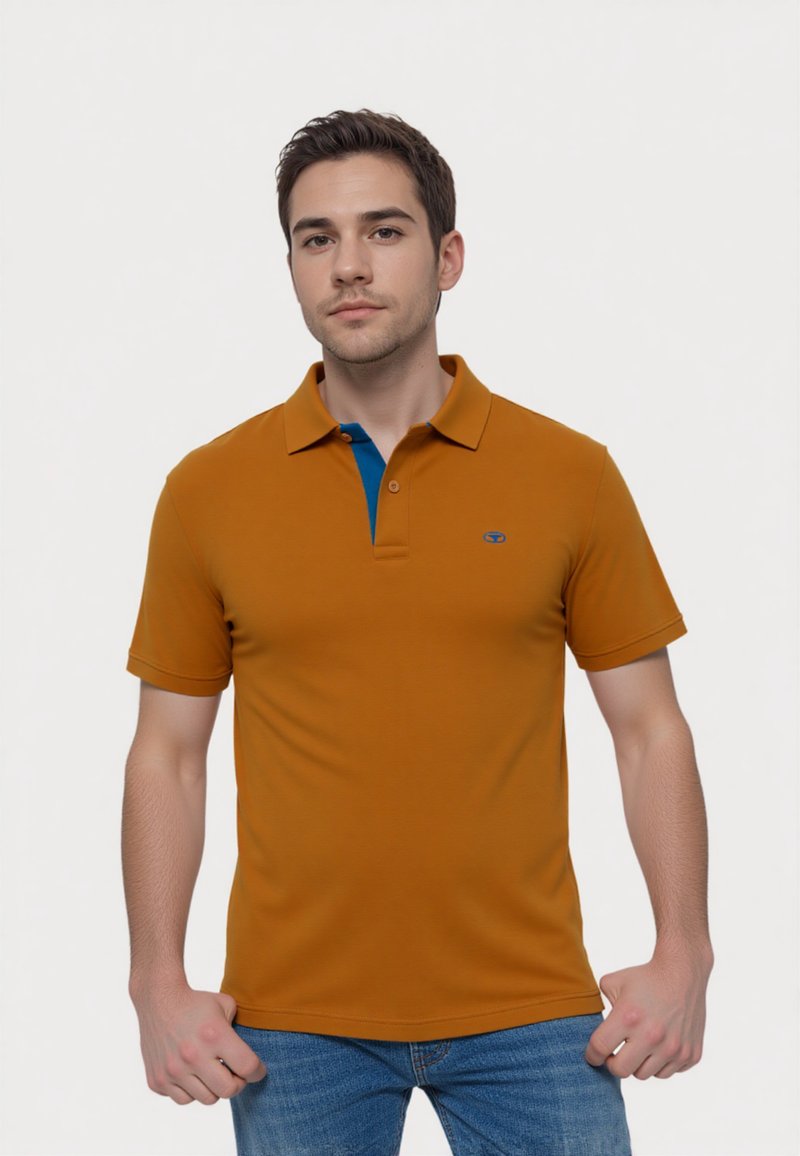 Short-sleeve polo shirt, orange with blue collar accent. Made of smooth fabric, featuring a small logo on the chest. Classic fit design.