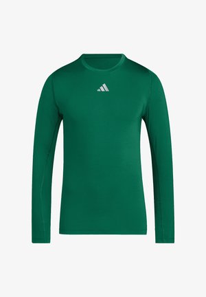 Mørkegrøn langærmet sportstrøje med lille hvidt Adidas-logo centreret under kraven.