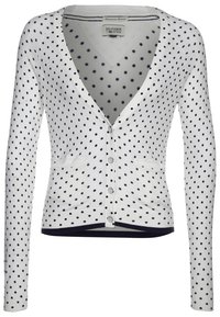 Vit cardigan med marinblå prickar, V-ringning, långa ärmar, knapplinje fram och två framfickor. Ribbad fåll och muddar.