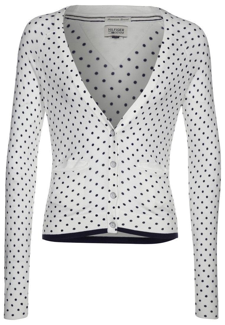Vit cardigan med marinblå prickar, V-ringning, långa ärmar, knapplinje fram och två framfickor. Ribbad fåll och muddar.