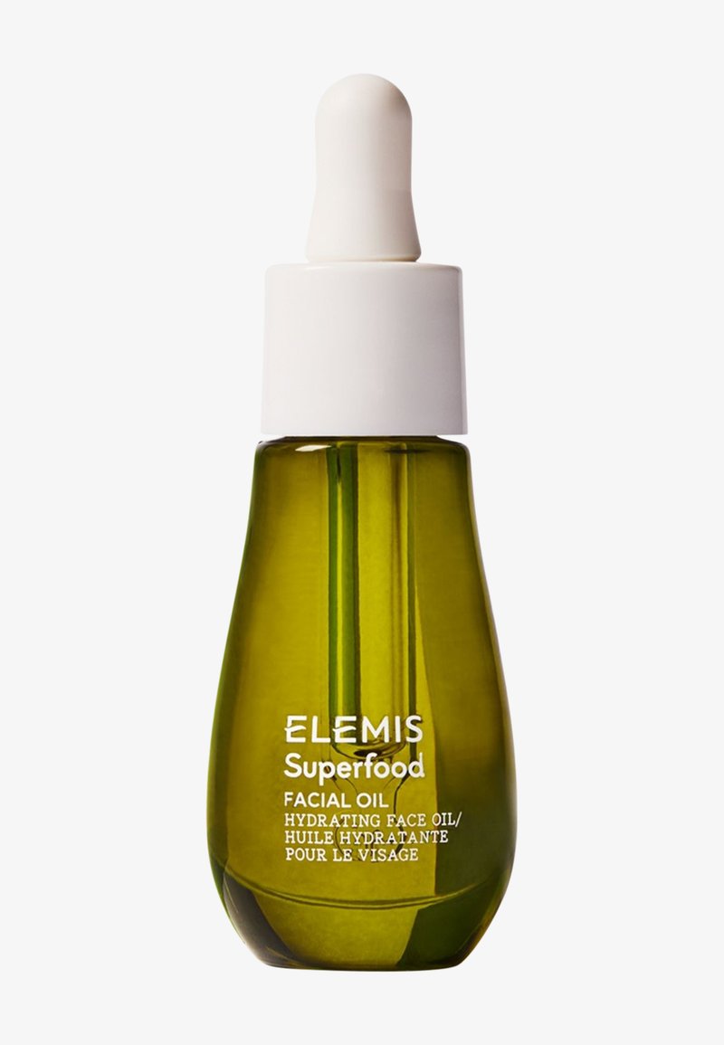 Botella de vidrio verde con cuentagotas de aceite facial hidratante Elemis Superfood con tapa blanca, sobre fondo blanco.
