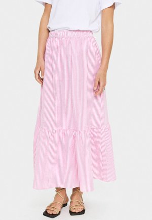 Pink and white striped maxi skirt with an elastic waistband, flared hem, and gathered texture. Paired with strappy flat sandals.