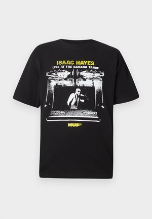 Black cotton t-shirt featuring a graphic print of a musician in a stage setting, with white and yellow text: "ISAAC HAYES LIVE AT THE SAHARA TAHOE."