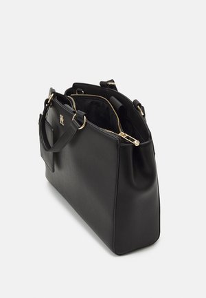 Black leather handbag with gold zipper and hardware, structured shape, open top, and two short handles on white background.