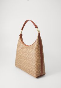 Borsa a tracolla con motivo marrone, corpo in tessuto beige, manici in pelle e hardware dorato. Presenta una chiusura a zip e una superficie liscia.