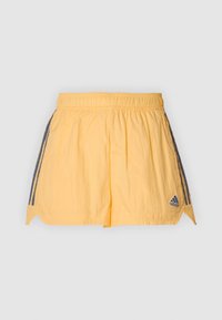 Gula träningsshorts med elastisk midja. Har mörkblå sidokanter och en liten logotyp längst ner till höger. Lättviktsmaterial.