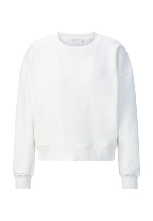 Valge lühendatud pusa pikkade varrukate ja soonikkoes mansettidega. Omaduseks lihtne disain ja pehme, sile kangas. Esiküljel on diskreetne logodetail.