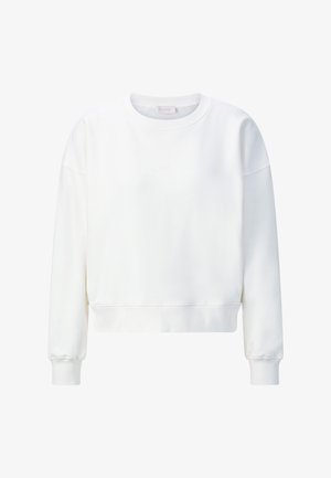 Valge lühendatud pusa pikkade varrukate ja soonikkoes mansettidega. Omaduseks lihtne disain ja pehme, sile kangas. Esiküljel on diskreetne logodetail.