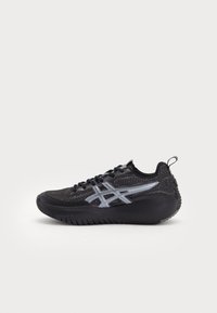 Black athletic shoe with mesh upper, rubber sole, and reflective silver accents, featuring a textured design and lace-up closure.