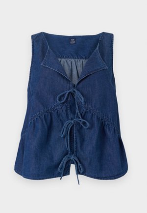 Tmavě modrý džínový top bez rukávů s špičatým límcem, detailem na zavazování vepředu a nařaseným pasem. Hladká textura s uvolněným střihem.