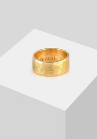 Hammered gold ring with a smooth inner band. Features a wide, textured surface and engraved branding on the inside.