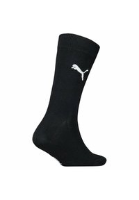 Sort atletisk sok lavet af glat strikstof. Har et hvidt Puma-logo på siden. Standard design med crew-højde.