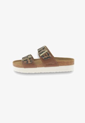 Brown sandals with two leopard print straps, gold buckles, and a white cork sole. Features a textured insole for comfort.