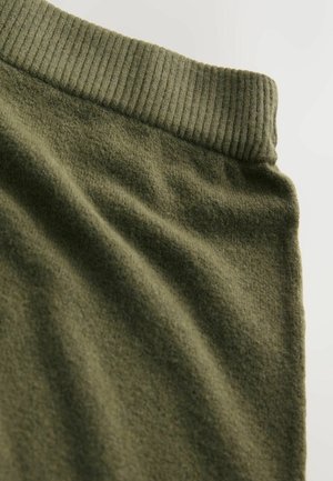 Olive green fabric with soft, textured surface; features a ribbed waistband along the top edge.