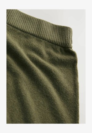 Olive green fabric with soft, textured surface; features a ribbed waistband along the top edge.