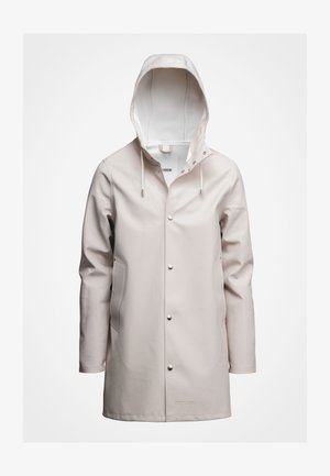 Lys beige regnfrakke med hætte, lavet af glat vandtæt materiale. Har trykknapper, snøre og sidelommer. Enkel design.